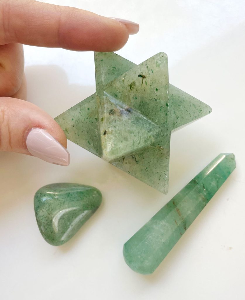 Various shapes of green aventurine crystal including a merkaba asteroid polished stone and polished point