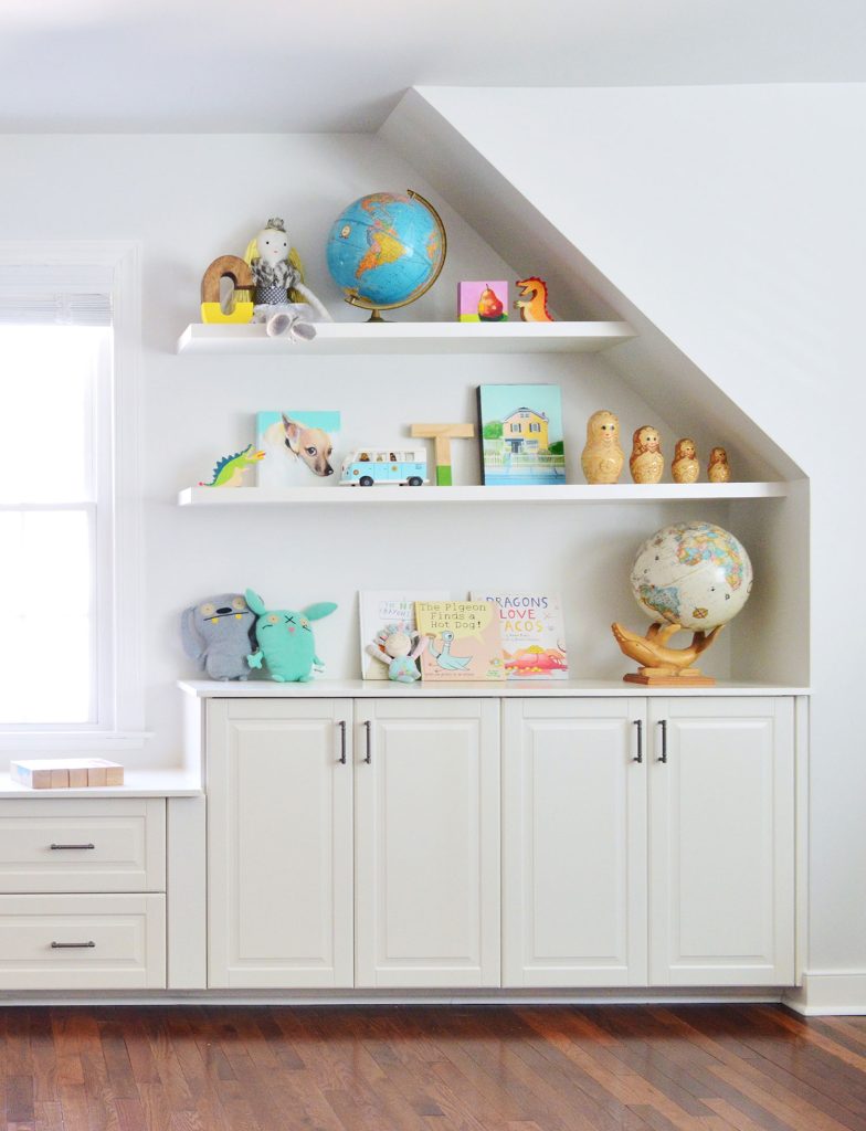 White Floating Shelves In Playroom With Toys Over Storage Cabinets