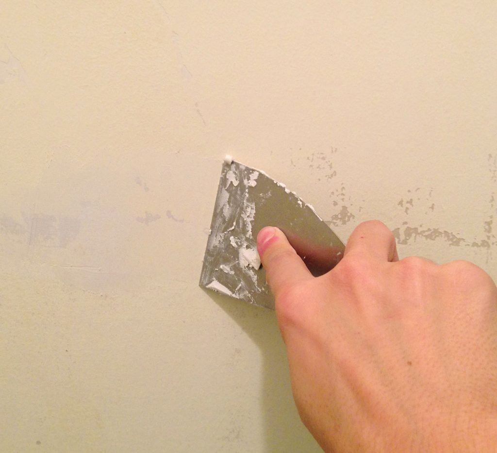 Spackling Peeled Paint Patches With A Putty Knife
