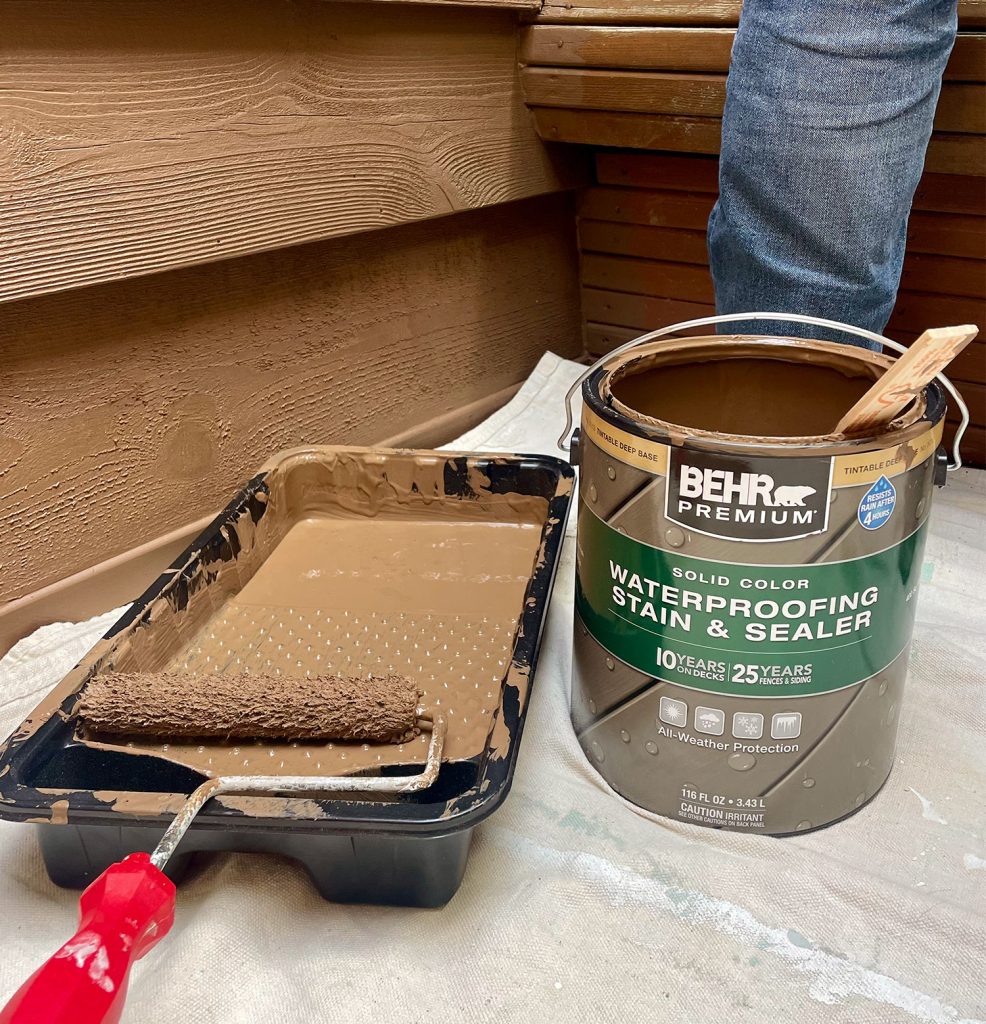 Can Of Behr Premium Solid Color Stain In Tugboat Next To Roller Tray