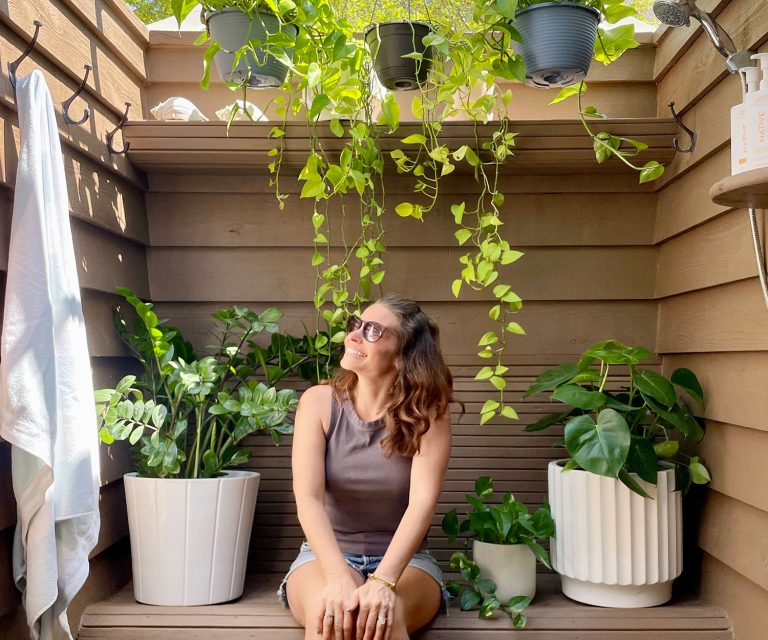 Sherry Sitting In Outdoor Shower Looking At Plants