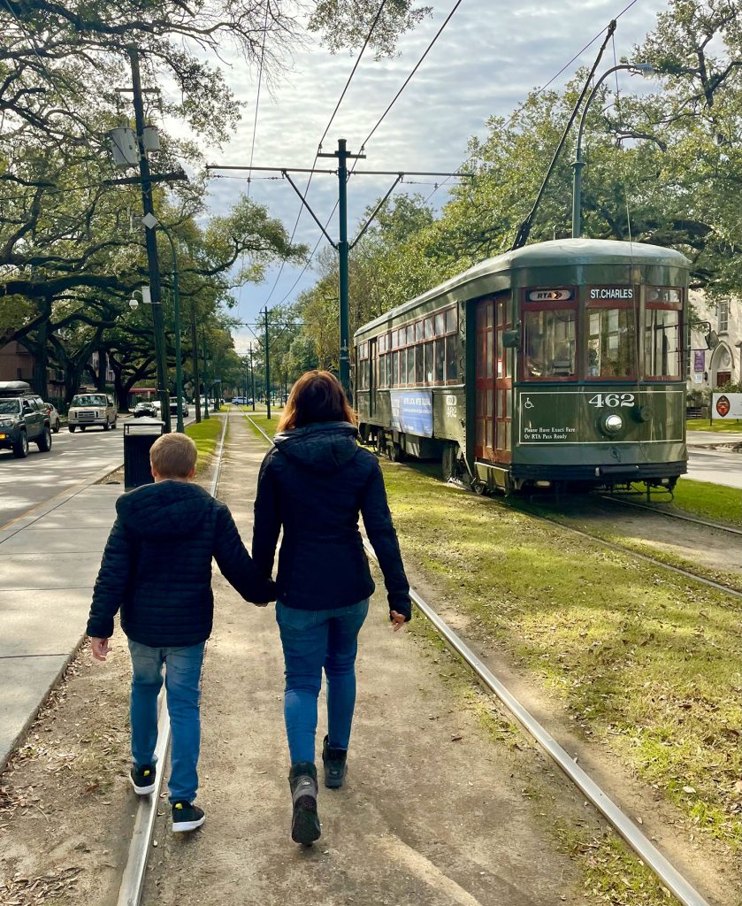 Mom And Child Walking Near New Orleans Street Car