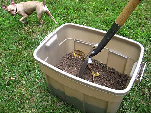 stirring compost bin with shovel