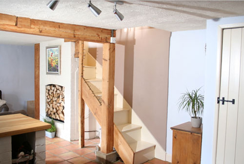 exposed light wood beam in english cottage including exposed staircase