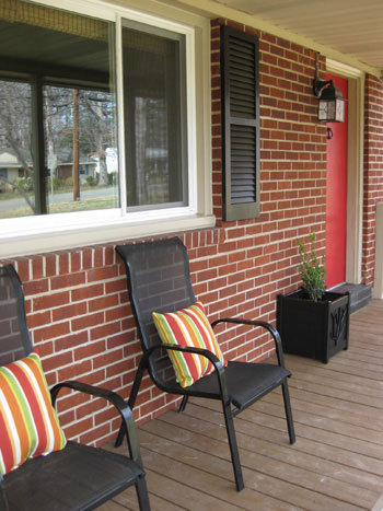 front-porch-decorating-seating-area-doorway-planter-red-door