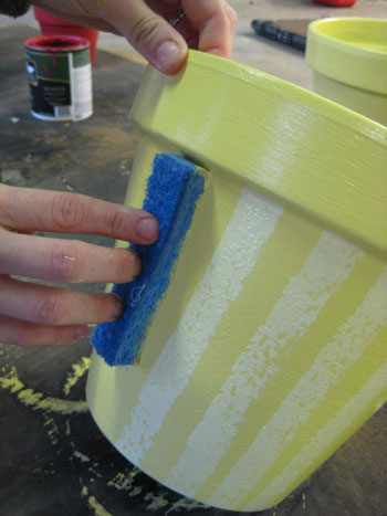 sponging striped paint pattern to terra cotta pot