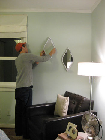 john-hangs-the-sconces-on-the-wall