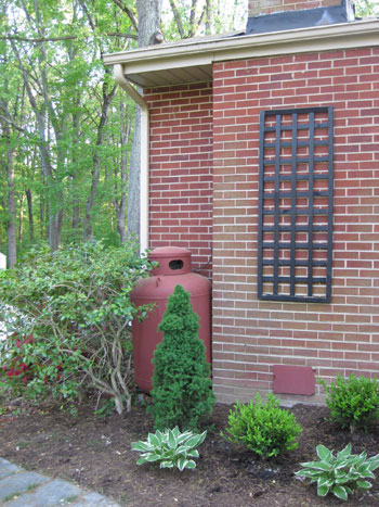 After photo of propane tank painted red to better match brick home exterior