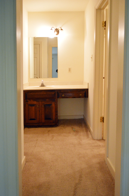 Before Photo Of Bathroom Vanity Nook With Carpet and Dark Wood Vanity