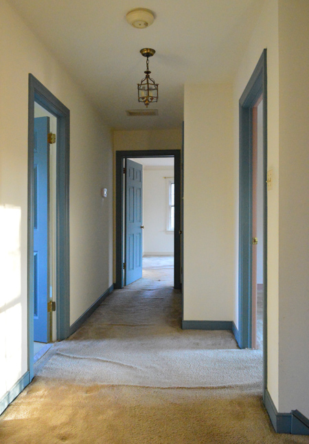 Before Photo Of Carpeted Upstairs Hall With Blue Trim