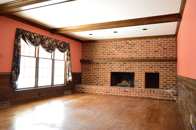 Before Photo of Family Room With Brick Fireplace And Salmon Pink Walls