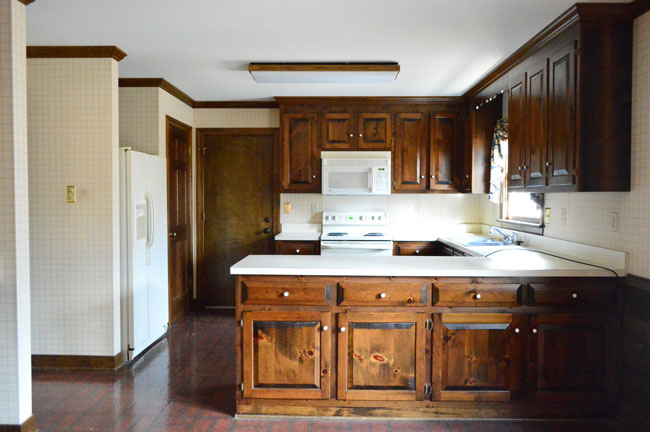 Before Photo Of Kitchen With Dark Wood Cabinets And Laminate Counters