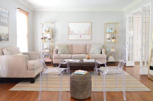 neutral living room decorated with shelves artwork and lots of seating