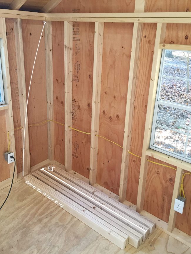 empty wall where garage shelving is going to go with 2x4s