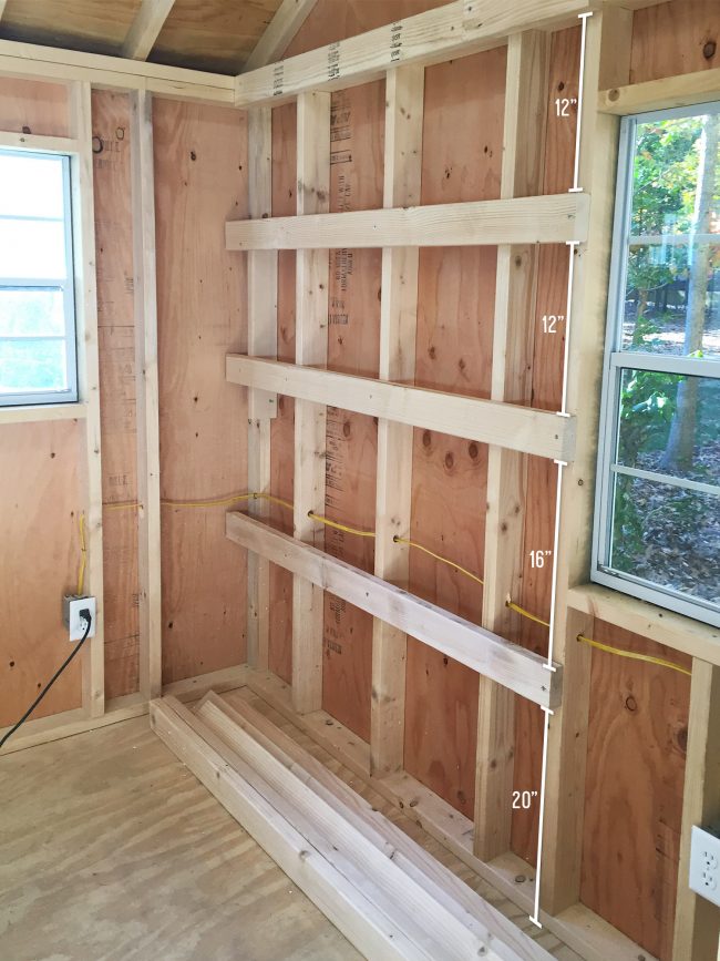 wood shelf supports attached to shed wall for DIY garage shelves