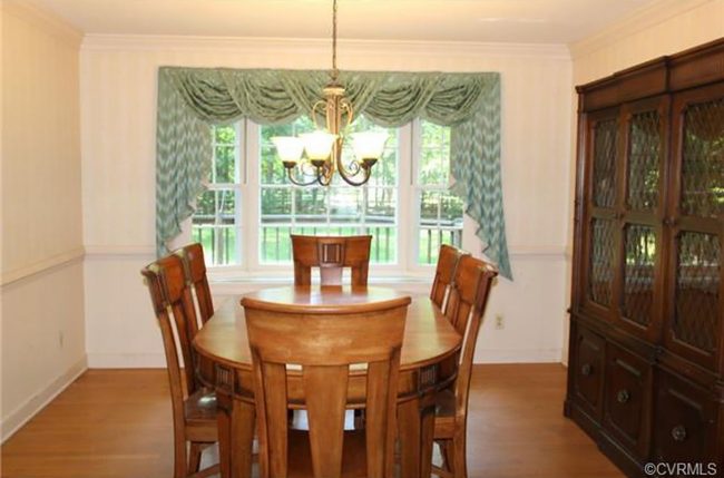 before photo of dining room with old curtain and large china cabinet