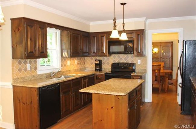 before photo of kitchen with brown cabinets and tan backsplash