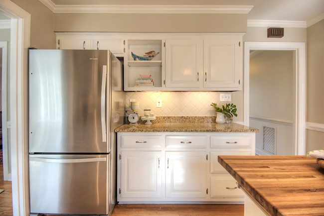 painted kitchen cabinets and clean stainless steel refrigerator