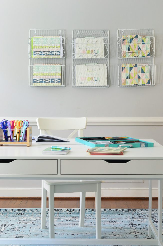 wall in homework room with file folders hanging on it