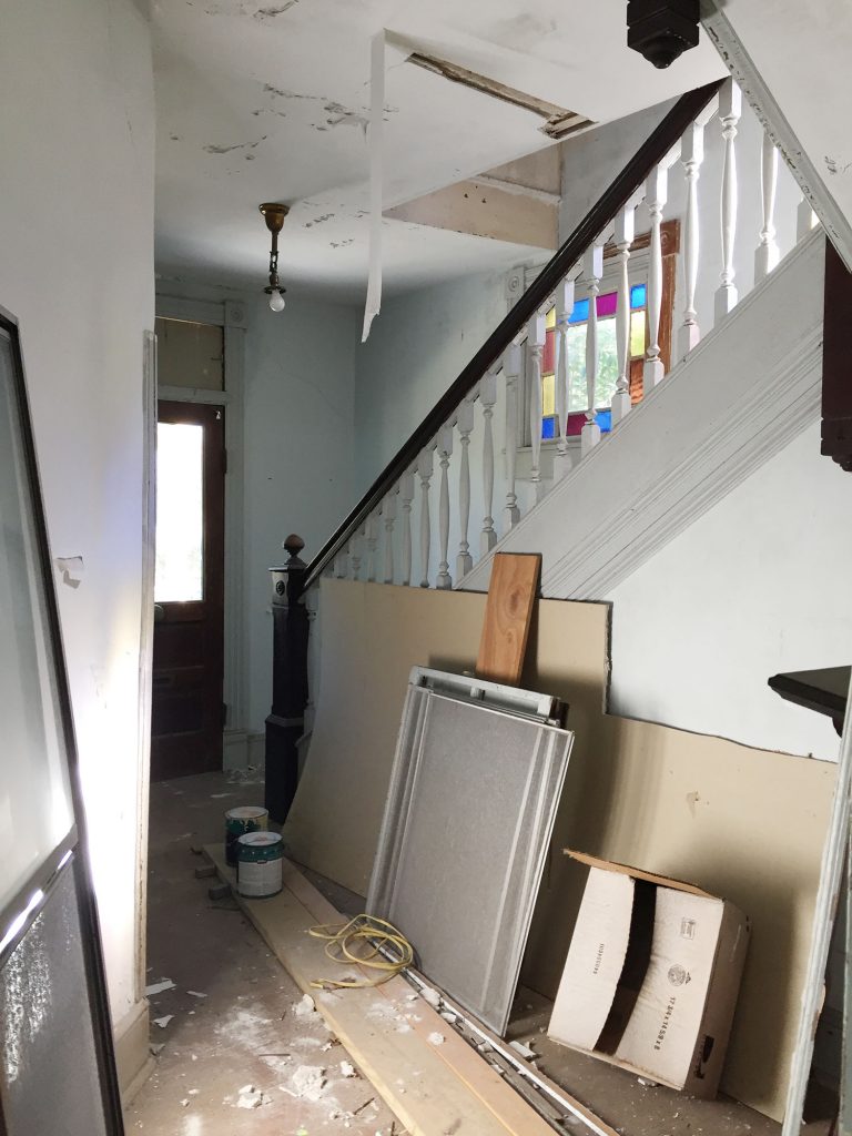 Before Photo Of Beach House Foyer With Crumbling Walls Turned Wood Railings Stained Glass Windows