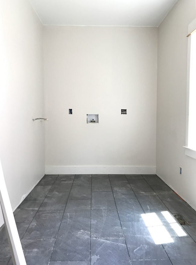 laundry room area after drywall paint and dark slate tile