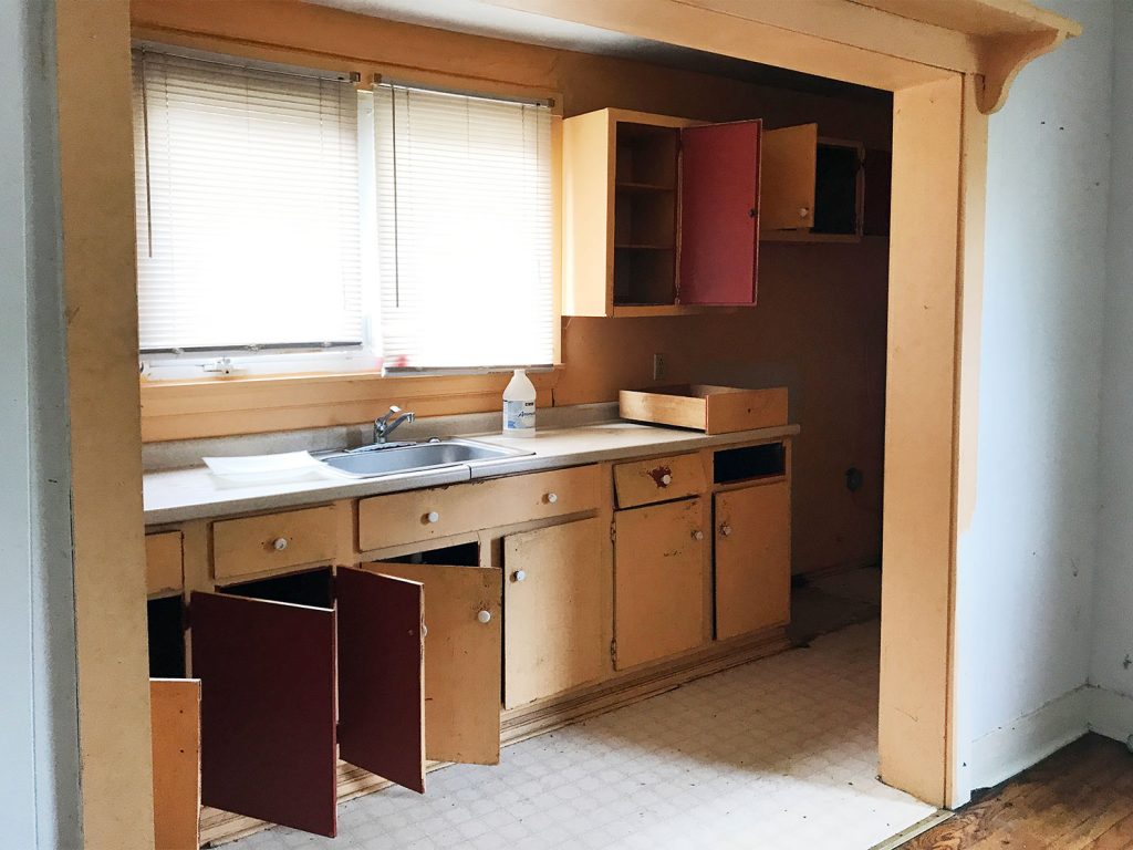 Before Photo Of Kitchen Hallway With Open Orange Cabinets