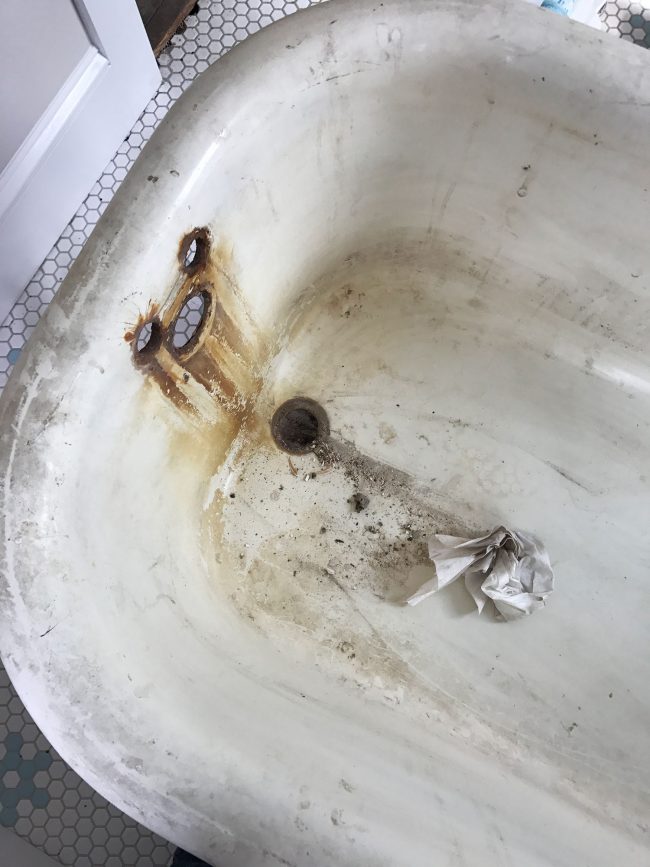 Rust stains around faucet holes in clawfoot tub