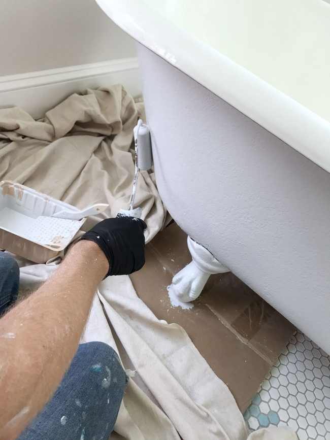 Applying primer to clawfoot tub using a small foam roller
