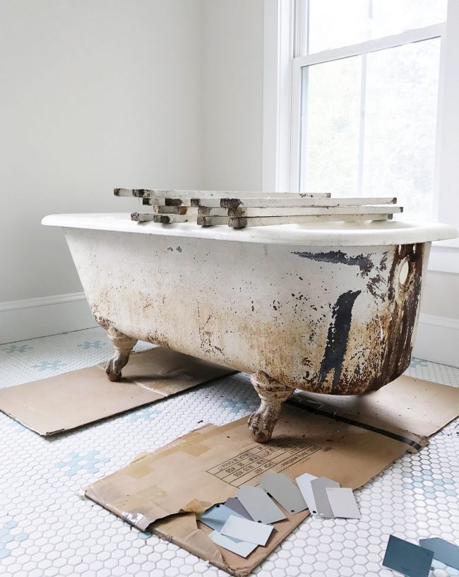 Dirty outside of clawfoot tub with rust stains