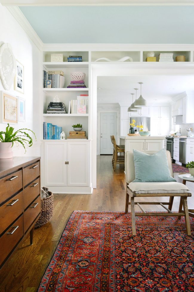 white built-in bookshelves around a doorway in living room