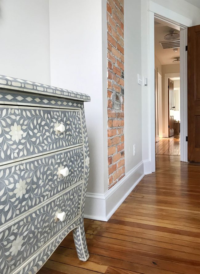 blue gray inlay detail next to exposed brick