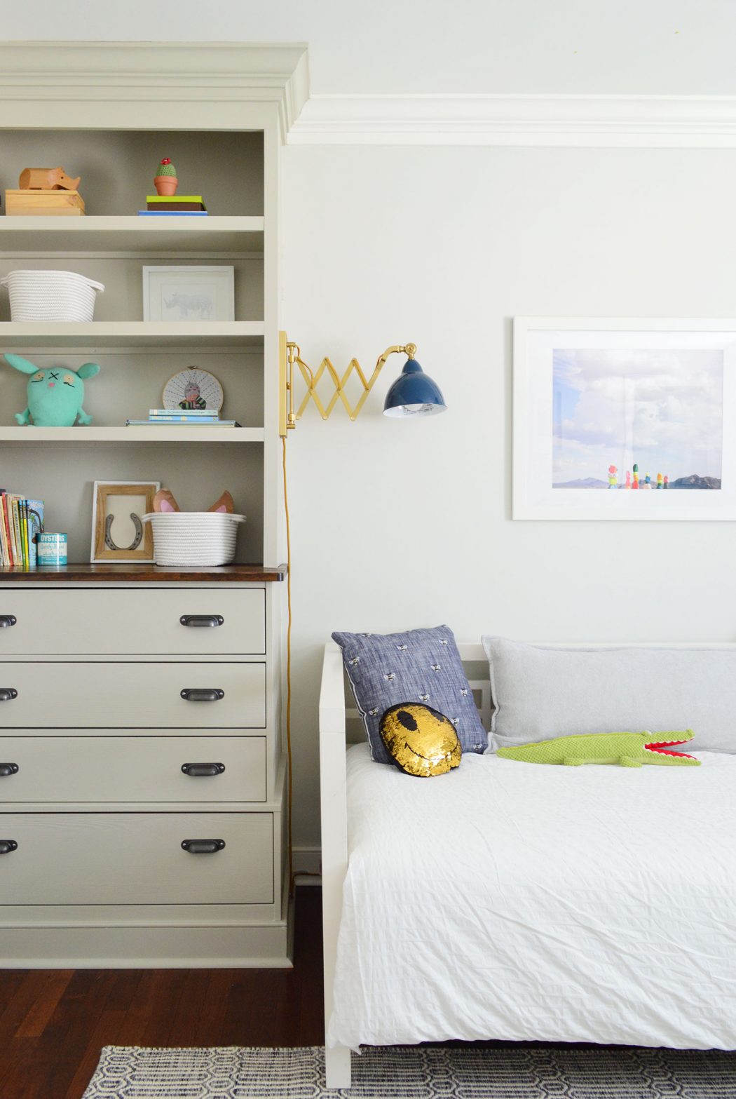 Boys bedroom with built-in floor to ceiling bookcases and dresser drawers in old house