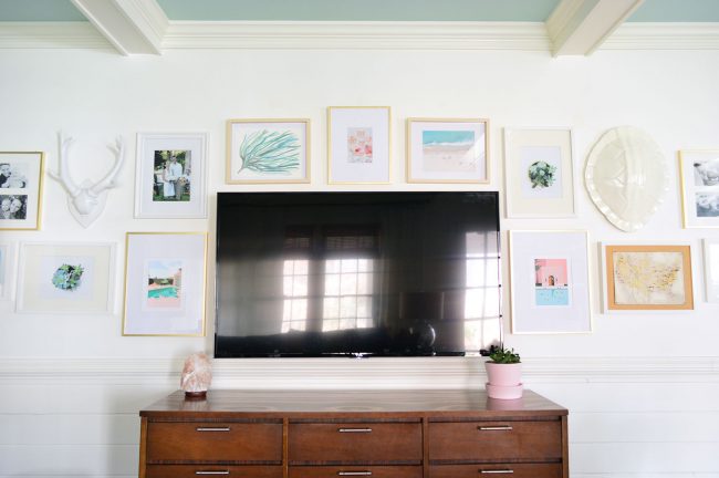 picture gallery wall around a tv on white walls