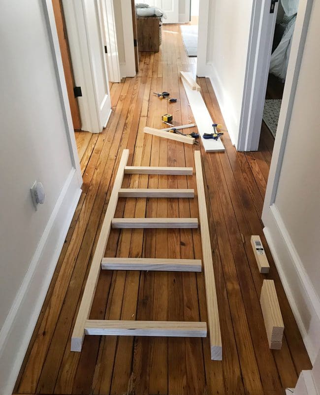 bunk bed ladder pieces laid out in hallway for construction