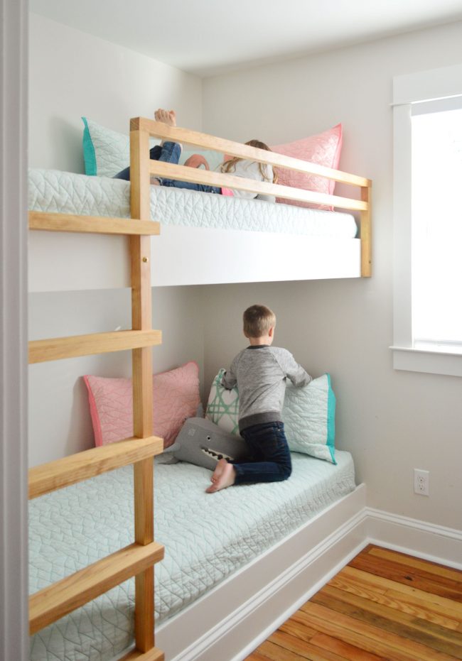 built in bunk beds in a small room with children on each bed