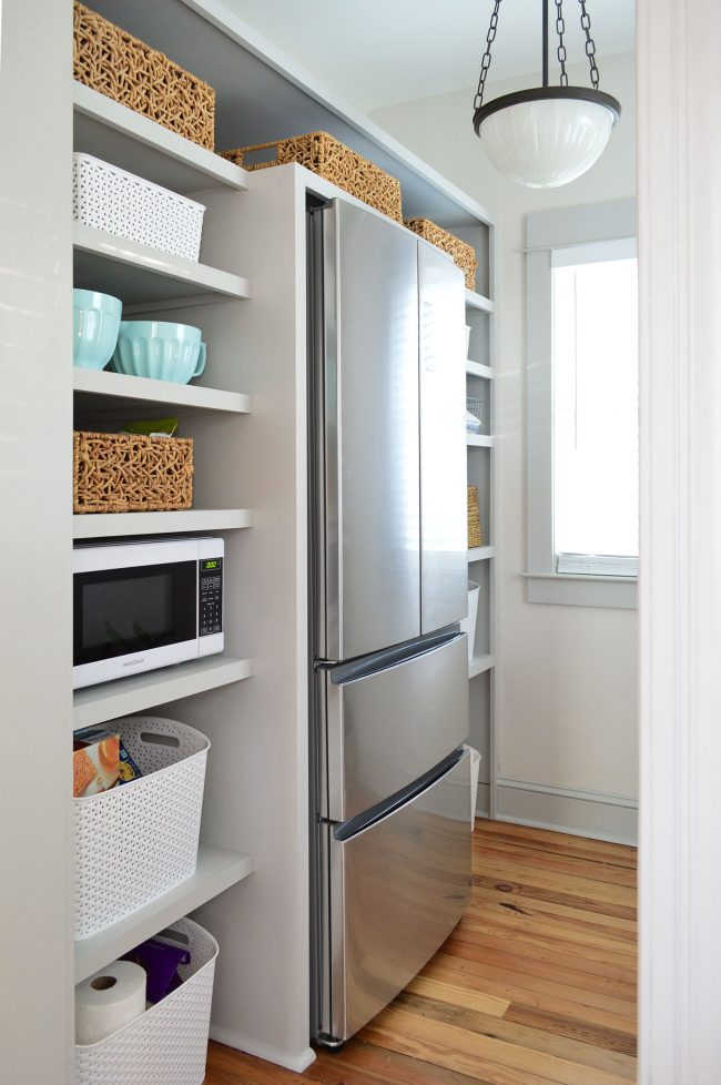 after photo of built in pantry shelving project painted gray with baskets on shelves