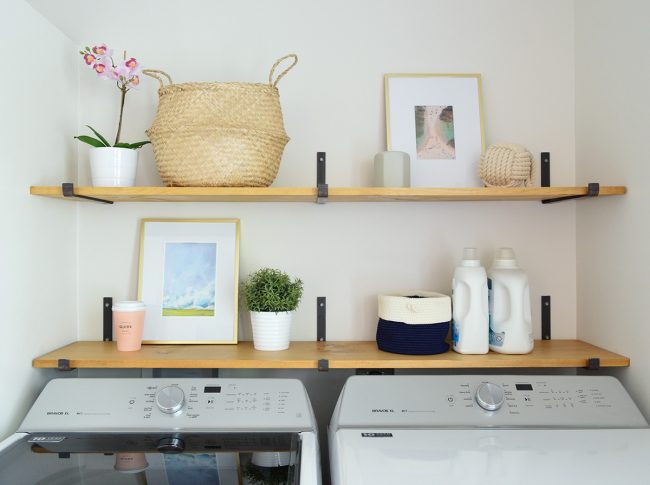 open shelves above top loading washing with dark iron brackets and wood shelves