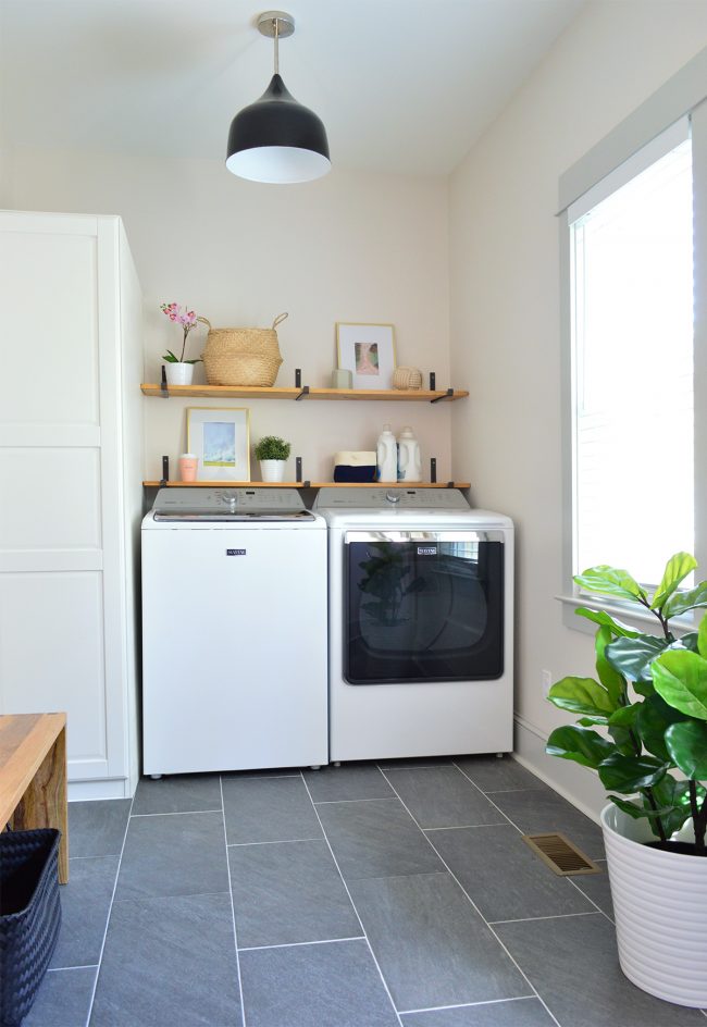 laundry room with slate floors black light fixture open wood shelves