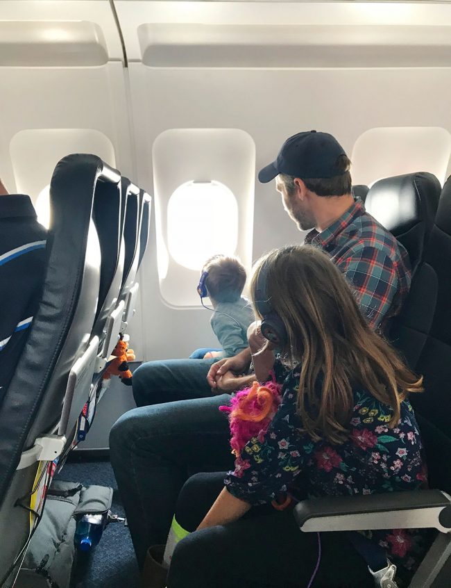 John and kids on plane to spring break in florida