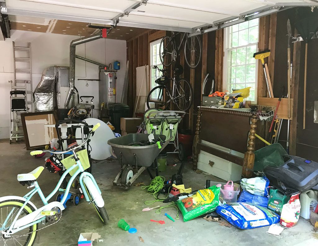 Garage Filled With Junk Like Bikes And Yard Equipment