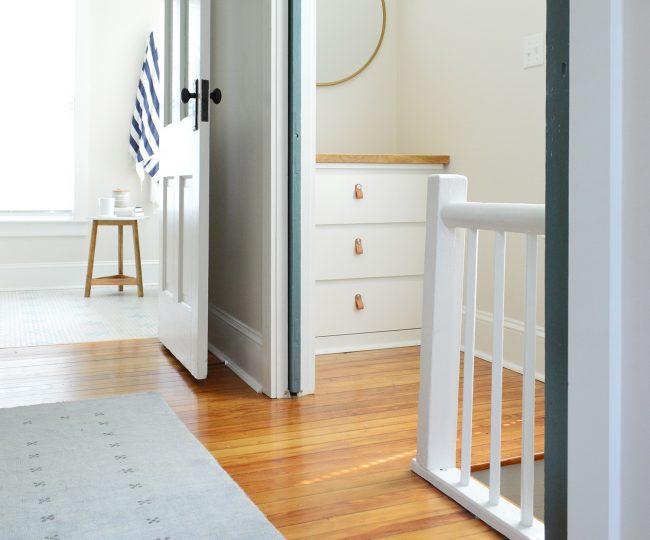 Upstairs Landing At The Top Of the Stairs With Dresser and Pocket Doors