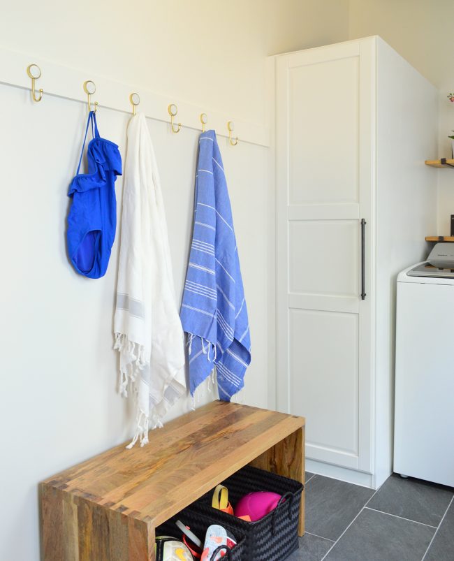 after photo of towels and bathing suit on hook rail in mudroom