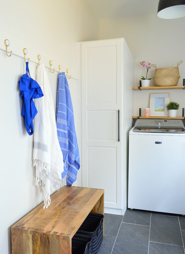 mudroom laundry room with long white coat hook rail