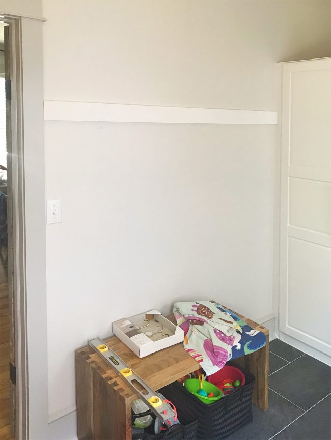 white board hung on wall in mudroom