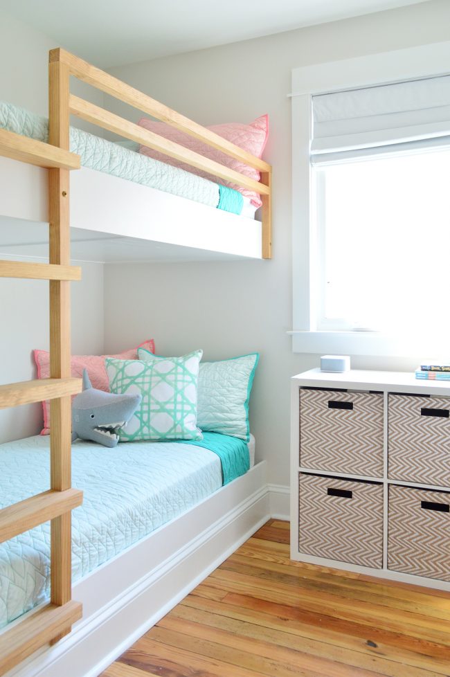 After Photo Of Beach House Bunk Room With DIY Floating Bunk Beds With Wood Railing And Small Cube Organizer