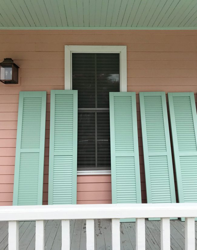 Duplex Exterior Shutters Leaned On Pink House 650x823
