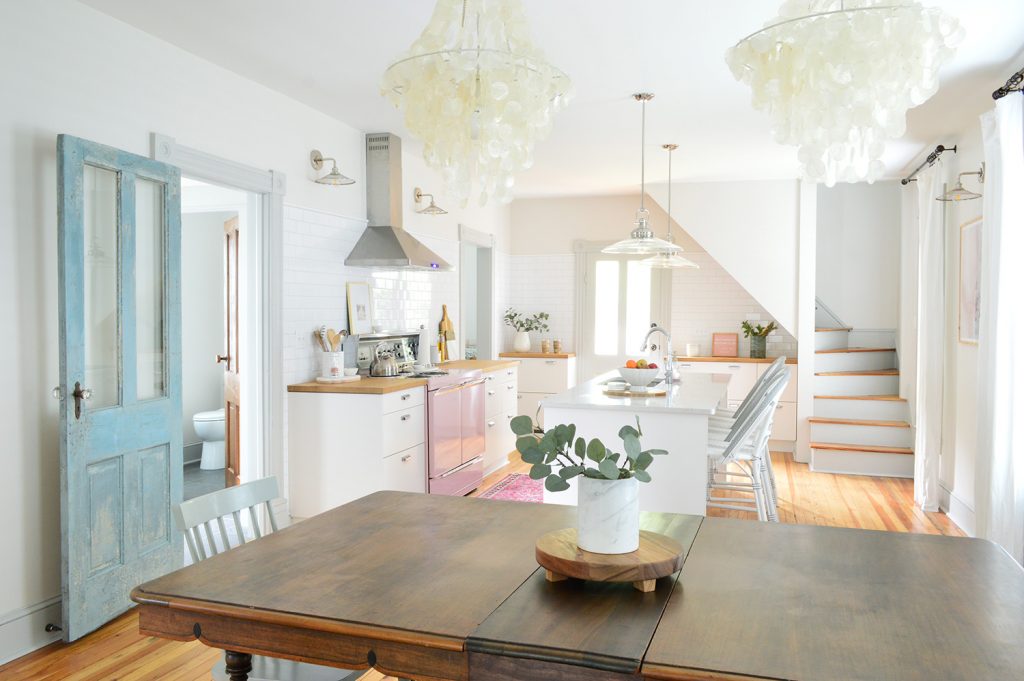 Beach house kitchen and dining room with faux greenery on table top