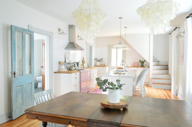 Finished Photo Of Beach House Kitchen With White Cabinets and Vintage Wood Dining Table