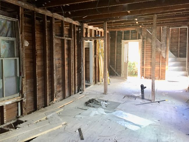 Demo Photo of Beach House Kitchen With Exposed Walls and Open Floor Plan