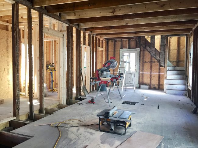 Reconstruction Photo Of Beach House Kitchen With New Framing And Open Concept